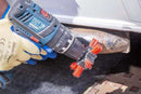 Abrasive Nylon Brush with red abrasive bristles and black plastic hub mounted on a cordless drill