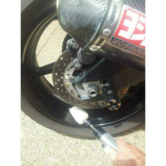 Alloy Wheel Metal Polishing tool buffing a glossy black motorcycle wheel with a handheld drill attachment