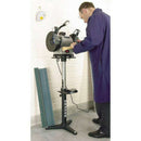 Bench Grinder Stand in black and silver metal with adjustable height, supporting a mounted bench grinder