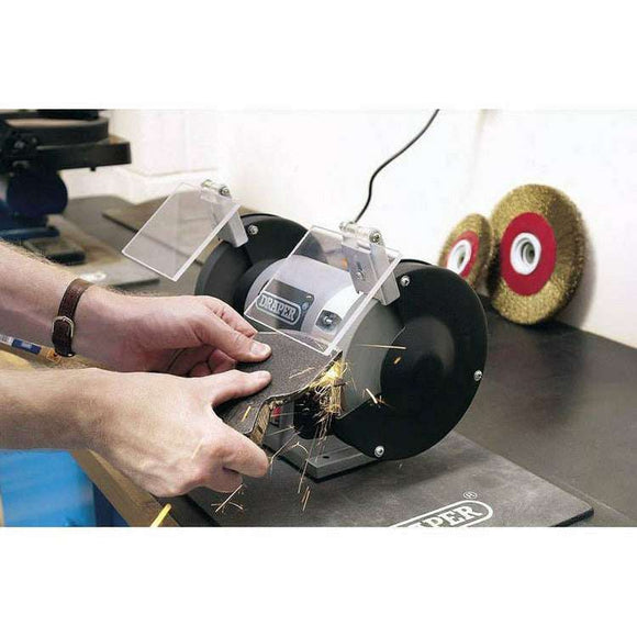 Draper 6" 250W bench grinder with dual wheels, clear eye shields and black guards in use