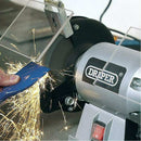 Draper 6" 250W bench grinder with silver motor, black wheel guard and visible sparks during grinding