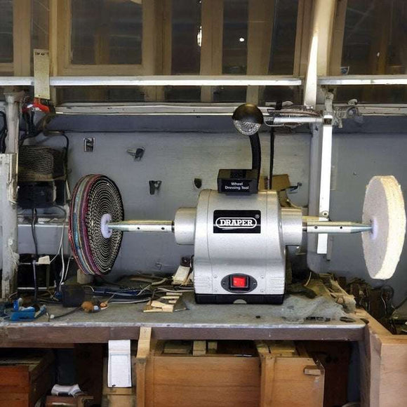 Draper 6" 370W Bench Grinder with a silver metal body, red switch and polishing wheels mounted on both spindles