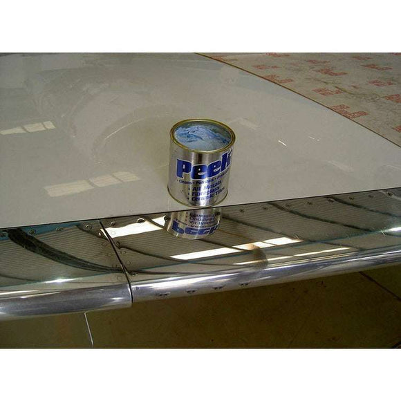 Peek Metal Polish 50ml silver tube with blue label, shown on a reflective polished metal surface