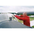 Peek Metal Polish tin beside a person polishing the riveted metal surface of a small aircraft