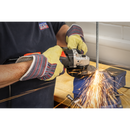 Sealey 115mm angle grinder with black and orange body cutting metal, producing bright sparks